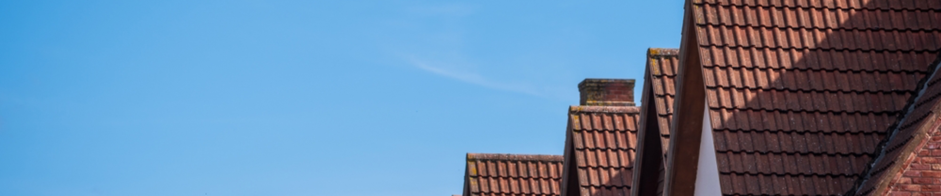 A row of houses, you can only see their roofs.