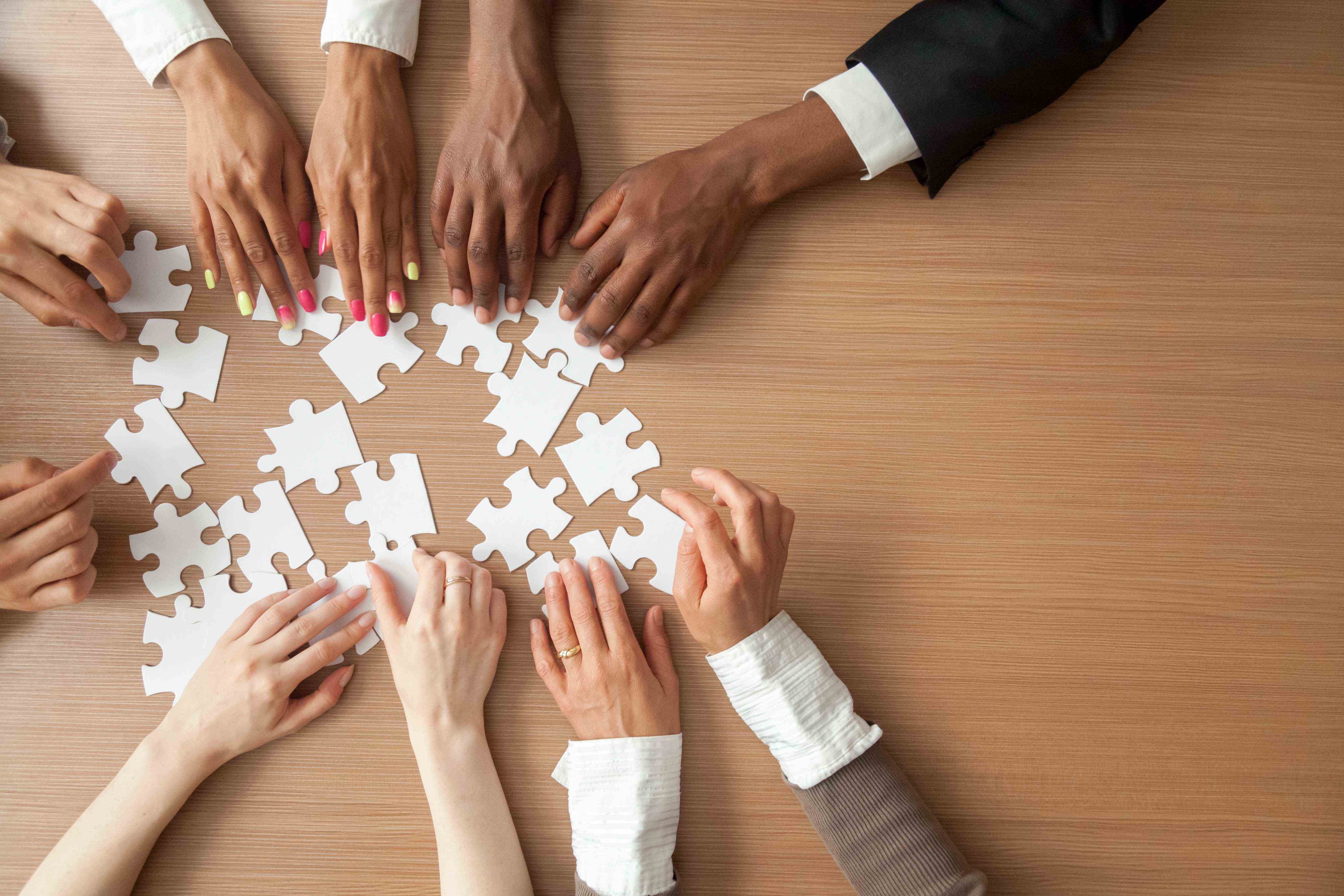 group of hands making a puzzle