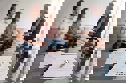 A couple speaking to someone about renting a house