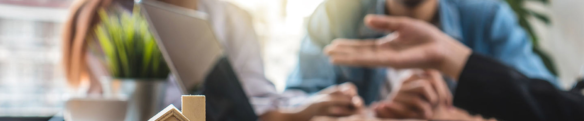 decorative stock image of people talking with a wooden housing in the forefront
